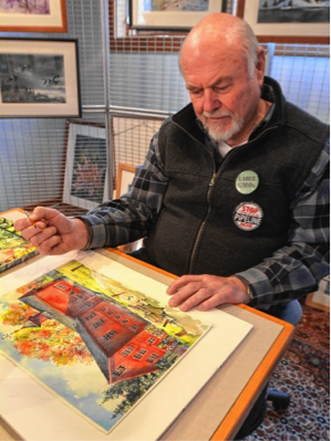 Walter Cudnohufsky pauses while working on a painting of the William Cullen Bryant Homestead barn at his studio in Ashfield, Friday, March 18.